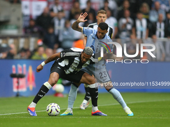 Tottenham Hotspur's Pedro Porro challenges Newcastle United's Joelinton during the Premier League match between Newcastle United and Tottenh...