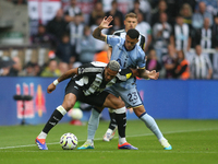 Tottenham Hotspur's Pedro Porro challenges Newcastle United's Joelinton during the Premier League match between Newcastle United and Tottenh...