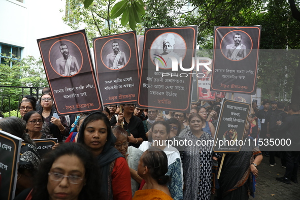 Ramakrishna Mission alumni and office staff take part in a protest march against a doctor's rape and murder in Kolkata, India, on September...