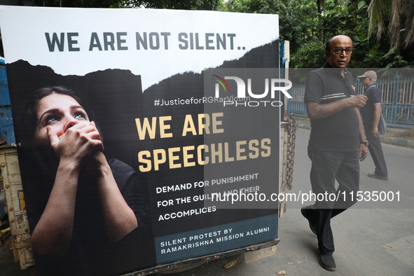 Ramakrishna Mission alumni and office staff take part in a protest march against a doctor's rape and murder in Kolkata, India, on September...