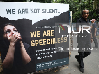 Ramakrishna Mission alumni and office staff take part in a protest march against a doctor's rape and murder in Kolkata, India, on September...