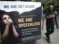 Ramakrishna Mission alumni and office staff take part in a protest march against a doctor's rape and murder in Kolkata, India, on September...