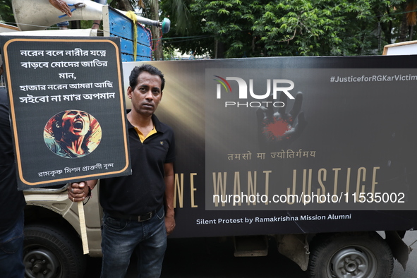 Ramakrishna Mission alumni and office staff take part in a protest march against a doctor's rape and murder in Kolkata, India, on September...