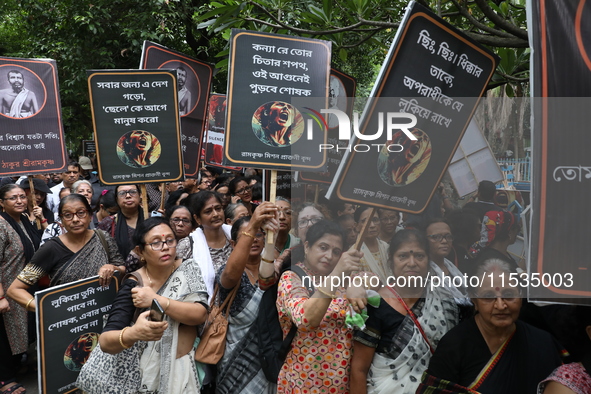 Ramakrishna Mission alumni and office staff take part in a protest march against a doctor's rape and murder in Kolkata, India, on September...