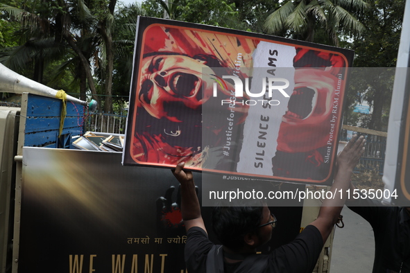 Ramakrishna Mission alumni and office staff take part in a protest march against a doctor's rape and murder in Kolkata, India, on September...