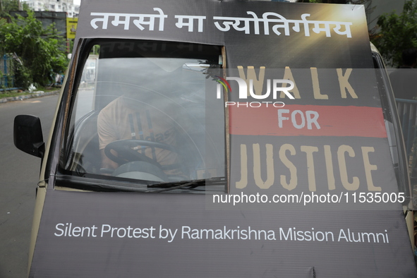 Ramakrishna Mission alumni and office staff take part in a protest march against a doctor's rape and murder in Kolkata, India, on September...