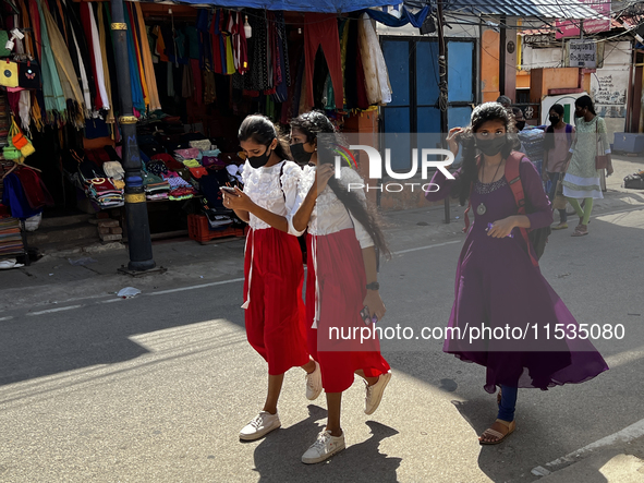 Girls walk along the road in the East Fort area in Thiruvananthapuram (Trivandrum), Kerala, India, on May 27, 2022. 