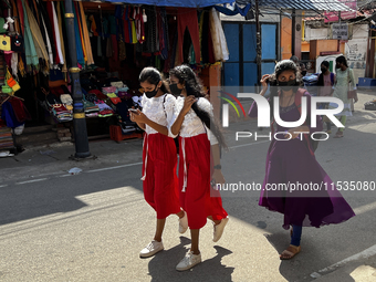 Girls walk along the road in the East Fort area in Thiruvananthapuram (Trivandrum), Kerala, India, on May 27, 2022. (