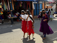 Girls walk along the road in the East Fort area in Thiruvananthapuram (Trivandrum), Kerala, India, on May 27, 2022. (