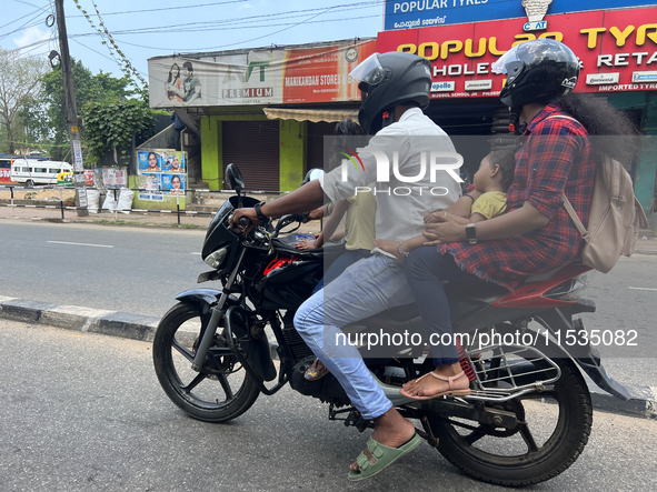 A family travels on a motorbike in Thiruvananthapuram (Trivandrum), Kerala, India, on April 2, 2024. 