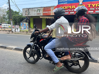 A family travels on a motorbike in Thiruvananthapuram (Trivandrum), Kerala, India, on April 2, 2024. (