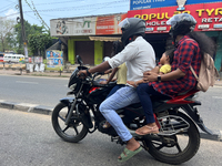 A family travels on a motorbike in Thiruvananthapuram (Trivandrum), Kerala, India, on April 2, 2024. (