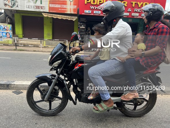 A family travels on a motorbike in Thiruvananthapuram (Trivandrum), Kerala, India, on April 2, 2024. 