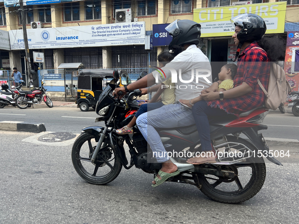 A family travels on a motorbike in Thiruvananthapuram (Trivandrum), Kerala, India, on April 2, 2024. 