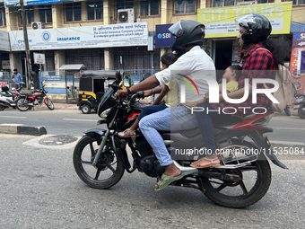 A family travels on a motorbike in Thiruvananthapuram (Trivandrum), Kerala, India, on April 2, 2024. (