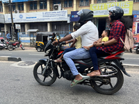 A family travels on a motorbike in Thiruvananthapuram (Trivandrum), Kerala, India, on April 2, 2024. (