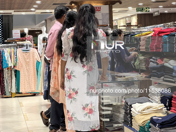 A woman shops for pants for a churidar at a textile shop in Thiruvananthapuram, Kerala, India, on April 10, 2024. 