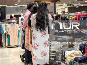 A woman shops for pants for a churidar at a textile shop in Thiruvananthapuram, Kerala, India, on April 10, 2024. (