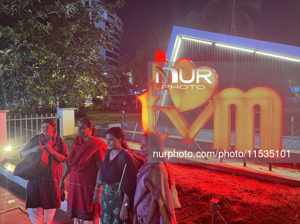 People pose by the 'I Love Trivandrum' sign in Thampanoor, Thiruvananthapuram (Trivandrum), Kerala, India, on April 1, 2024. 