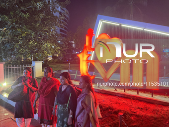 People pose by the 'I Love Trivandrum' sign in Thampanoor, Thiruvananthapuram (Trivandrum), Kerala, India, on April 1, 2024. (