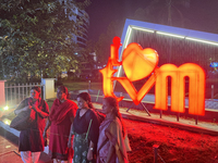 People pose by the 'I Love Trivandrum' sign in Thampanoor, Thiruvananthapuram (Trivandrum), Kerala, India, on April 1, 2024. (