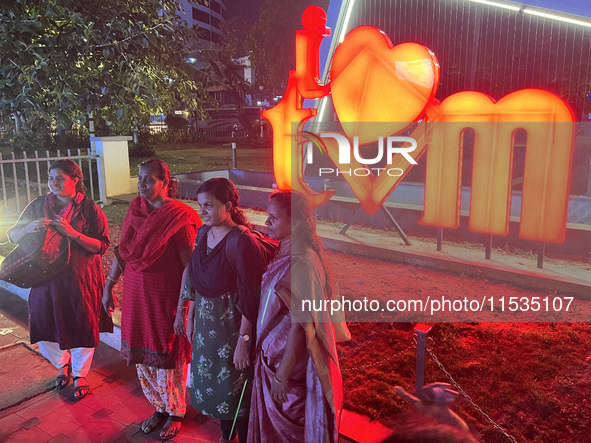 People pose by the 'I Love Trivandrum' sign in Thampanoor, Thiruvananthapuram (Trivandrum), Kerala, India, on April 1, 2024. 