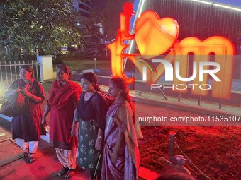 People pose by the 'I Love Trivandrum' sign in Thampanoor, Thiruvananthapuram (Trivandrum), Kerala, India, on April 1, 2024. (