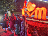 People pose by the 'I Love Trivandrum' sign in Thampanoor, Thiruvananthapuram (Trivandrum), Kerala, India, on April 1, 2024. (