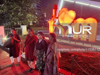 People pose by the 'I Love Trivandrum' sign in Thampanoor, Thiruvananthapuram (Trivandrum), Kerala, India, on April 1, 2024. (