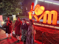 People pose by the 'I Love Trivandrum' sign in Thampanoor, Thiruvananthapuram (Trivandrum), Kerala, India, on April 1, 2024. (