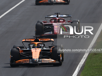 Oscar Piastri of McLaren, Charles Leclerc of Ferrari, Lando Norris of McLaren and Carlos Sainz of Ferrari during the Formula 1 Italian Grand...