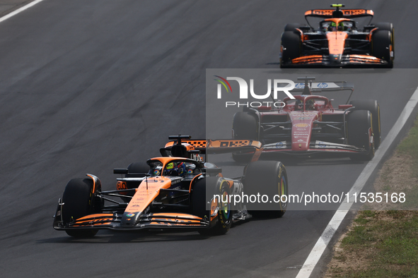 Oscar Piastri of McLaren, Charles Leclerc of Ferrari and Lando Norris of McLaren during the Formula 1 Italian Grand Prix at Autodromo Nazion...