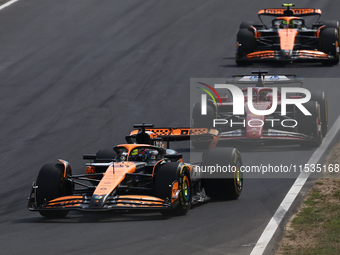 Oscar Piastri of McLaren, Charles Leclerc of Ferrari and Lando Norris of McLaren during the Formula 1 Italian Grand Prix at Autodromo Nazion...