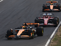 Oscar Piastri of McLaren, Charles Leclerc of Ferrari and Lando Norris of McLaren during the Formula 1 Italian Grand Prix at Autodromo Nazion...