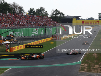 Oscar Piastri of McLaren, Charles Leclerc of Ferrari, Lando Norris of McLaren and Carlos Sainz of Ferrari during the Formula 1 Italian Grand...