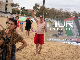 Dozens of activists participate in the international initiative ''Swim With Gaza'' on Nova Icaria beach, in Barcelona, Spain, on September 1...