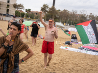 Dozens of activists participate in the international initiative ''Swim With Gaza'' on Nova Icaria beach, in Barcelona, Spain, on September 1...