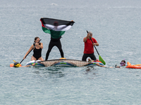 Dozens of activists participate in the international initiative ''Swim With Gaza'' on Nova Icaria beach, in Barcelona, Spain, on September 1...