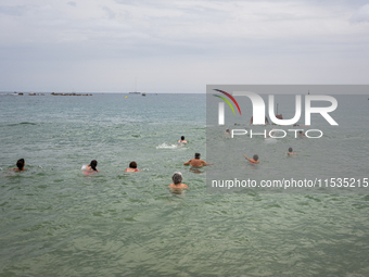 Dozens of activists participate in the international initiative ''Swim With Gaza'' on Nova Icaria beach, in Barcelona, Spain, on September 1...