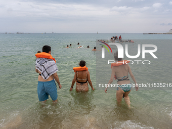 Dozens of activists participate in the international initiative ''Swim With Gaza'' on Nova Icaria beach, in Barcelona, Spain, on September 1...