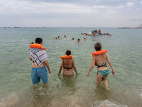 Dozens of activists participate in the international initiative ''Swim With Gaza'' on Nova Icaria beach, in Barcelona, Spain, on September 1...