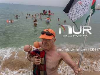 Dozens of activists participate in the international initiative ''Swim With Gaza'' on Nova Icaria beach, in Barcelona, Spain, on September 1...