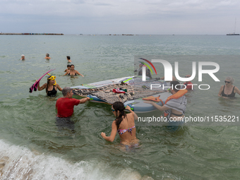 Dozens of activists participate in the international initiative ''Swim With Gaza'' on Nova Icaria beach, in Barcelona, Spain, on September 1...