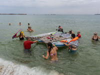 Dozens of activists participate in the international initiative ''Swim With Gaza'' on Nova Icaria beach, in Barcelona, Spain, on September 1...