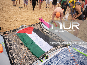 Dozens of activists participate in the international initiative ''Swim With Gaza'' on Nova Icaria beach, in Barcelona, Spain, on September 1...