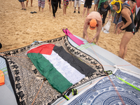 Dozens of activists participate in the international initiative ''Swim With Gaza'' on Nova Icaria beach, in Barcelona, Spain, on September 1...