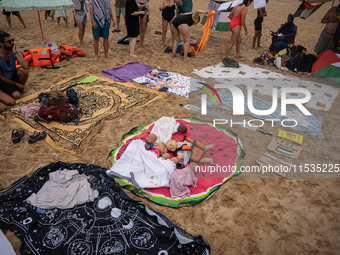 Dozens of activists participate in the international initiative ''Swim With Gaza'' on Nova Icaria beach, in Barcelona, Spain, on September 1...