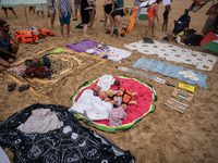 Dozens of activists participate in the international initiative ''Swim With Gaza'' on Nova Icaria beach, in Barcelona, Spain, on September 1...