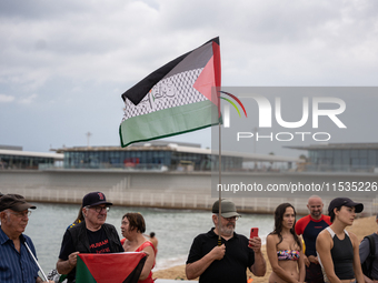 Dozens of activists participate in the international initiative ''Swim With Gaza'' on Nova Icaria beach, in Barcelona, Spain, on September 1...