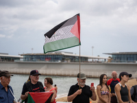 Dozens of activists participate in the international initiative ''Swim With Gaza'' on Nova Icaria beach, in Barcelona, Spain, on September 1...